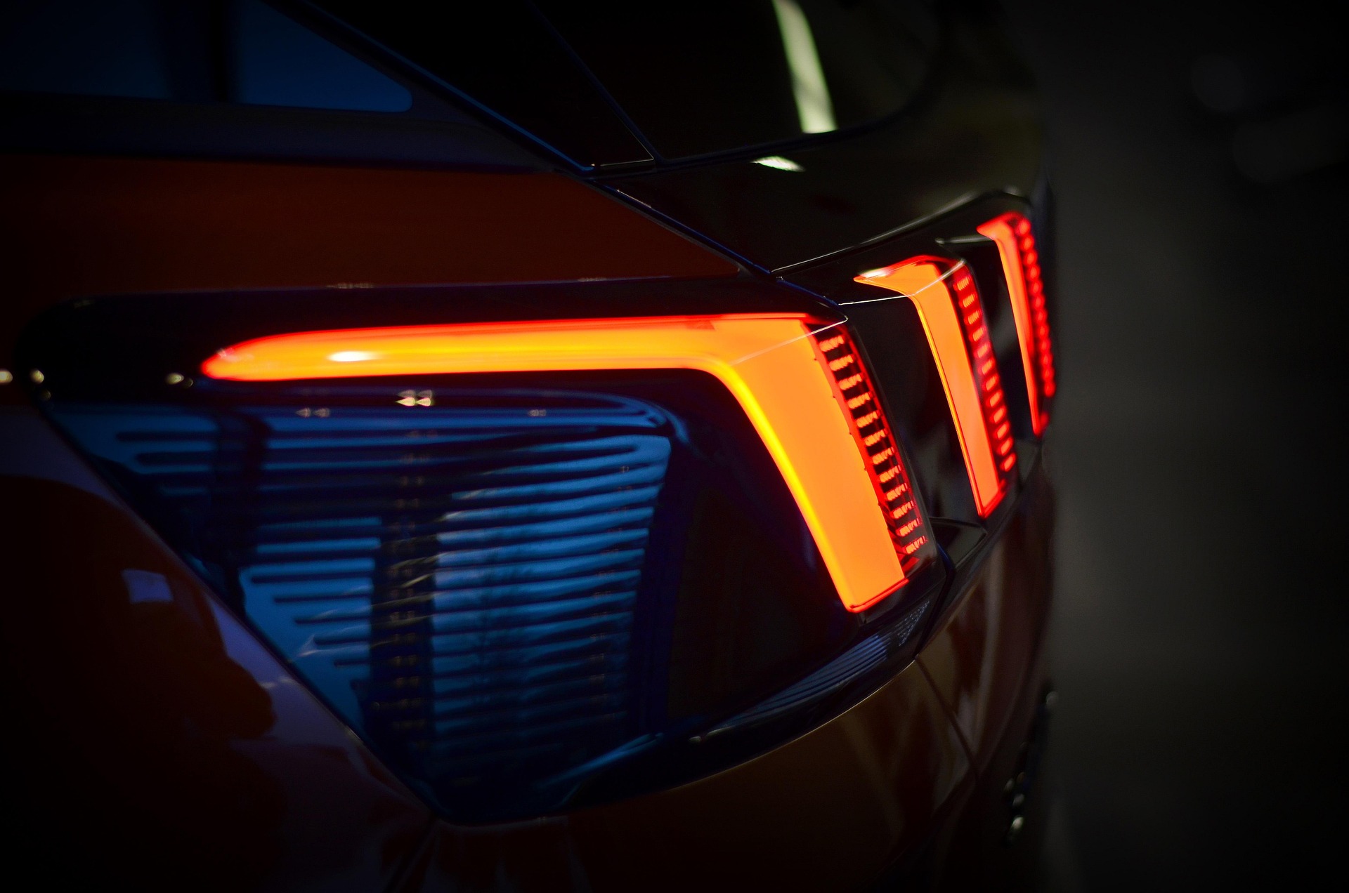 Close-up of a sleek car interior showcasing a modern steering wheel and dashboard design.